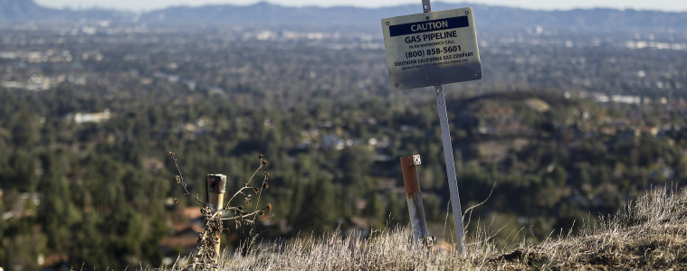 Warning signs line the Santa Susana Mountain range near Southern California Gas Company's fenced-off Aliso Canyon facility. A well at the site has been leaking methane since October. Photo: Scott L via Flickr