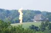 A flare from a fracking well burns off excess gas near a home.