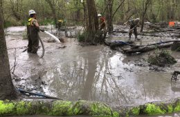 crew cleans up spill