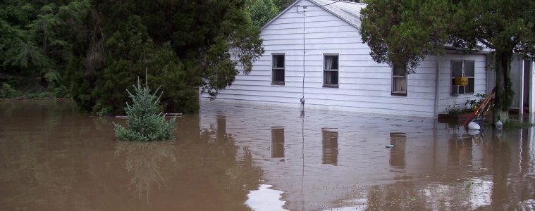 Only the second floor of a house is visible in flood waters