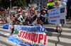 Climate Change Protestors on the steps of the state capitol with a sign that reads," Harrisburg Stand Uo."