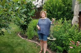 Cindi Fink with an empty birdfeeder.