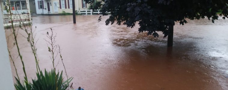 brown Floodwater on the streets near a home