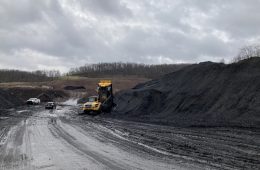 A dumptruck at a large pile of waste coal