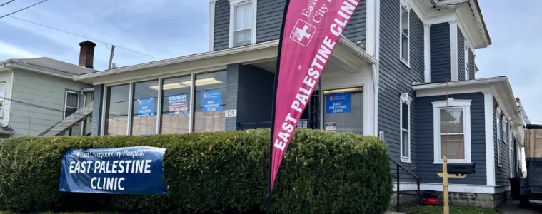 A large 2-story home turned into an office, with a banner outside reading "East Palestine Clnic"