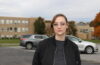 Zsuzsa Gyenes stands in a parking lot.