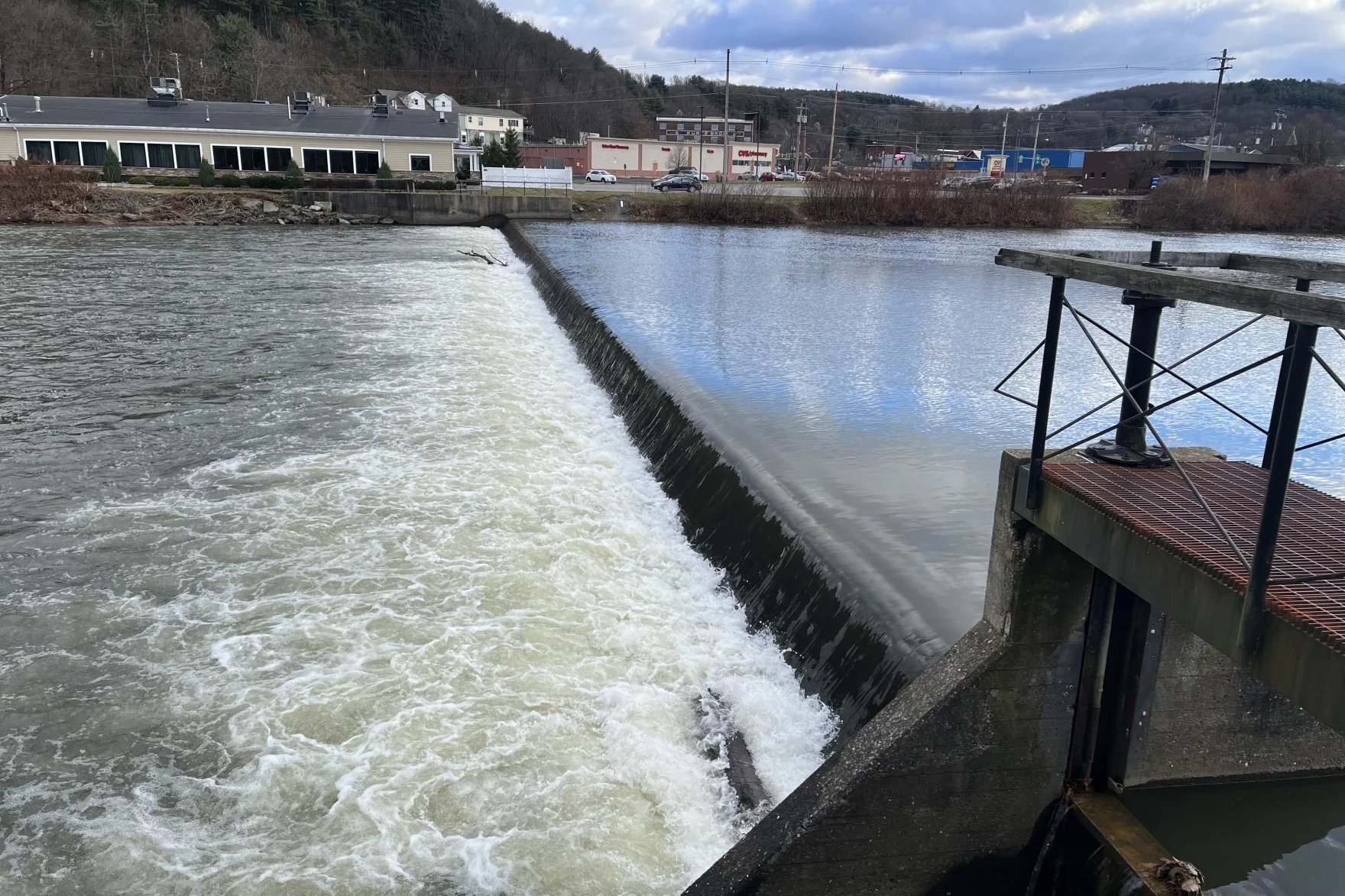 A low head dam along a wide river.